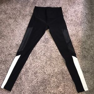 Leggings with leather, mesh, and white detailing